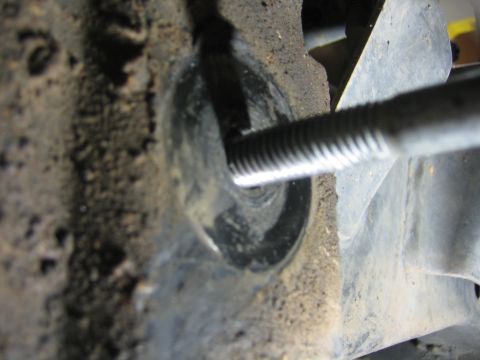 2001 Jeep Wrangler - Close-up view of a bolt threaded into a metal bracket, likely part of a vehicle's suspension or frame.