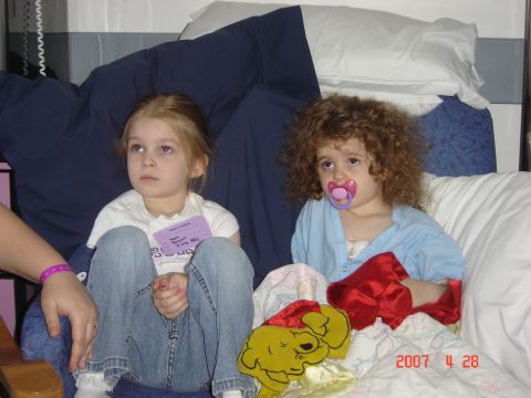 1993 Ford Bronco - Two young girls sit together, one with a pacifier, surrounded by blankets and pillows.