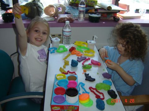 1993 Ford Bronco - Children engaged in creative play with modeling clay and various shaped cutters, with bottles and containers on the table.
