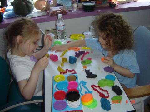 1993 Ford Bronco - Children engaged in creative play with modeling clay at a table, with a bottle of water nearby.
