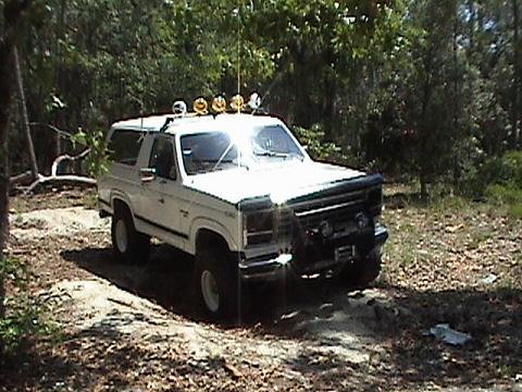 1986 Ford Bronco - This 1986 Ford Bronco is equipped with multiple off-road lights, suggesting it is used for trail riding or off-roading.