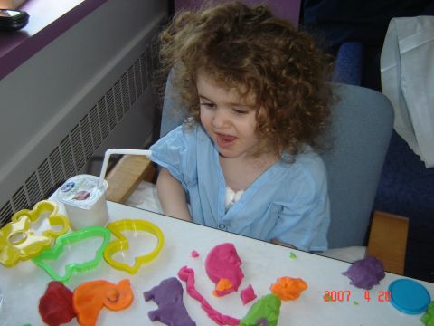 1993 Ford Bronco - Child in a blue gown playing with play-doh and cookie cutters on a table.