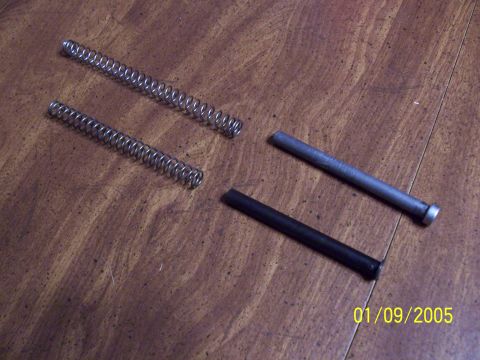 2000 Nissan Xterra - Two metal springs and two rods are laid out on a wooden surface, with a date stamp of 01/09/2005.