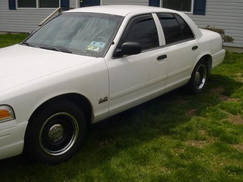 2002 Ford Crown Victoria - White 2002 Ford Crown Victoria parked on grass in front of a house.