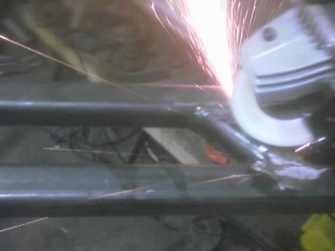 1989 Ford Bronco - Metal fabrication in progress with sparks from an angle grinder.