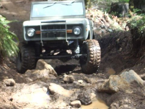 1968 Ford Bronco - This 1968 Ford Bronco is shown tackling a challenging off-road course with steep inclines and rough terrain.