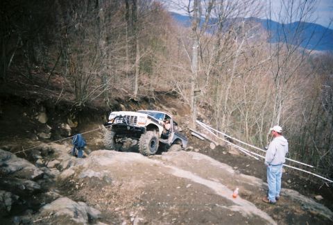 1978 Ford Bronco - A modified 1978 Ford Bronco navigates a challenging off-road course with steep inclines and rocky terrain.