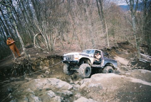 1978 Ford Bronco - Off-roading adventure: a 1978 Ford Bronco tackles a challenging rocky incline.