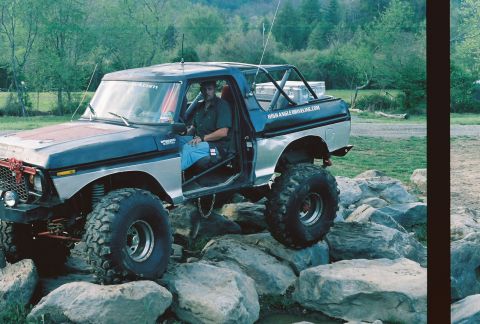 1978 Ford Bronco - A Ford Bronco is parked on a rocky surface, possibly in a natural setting.