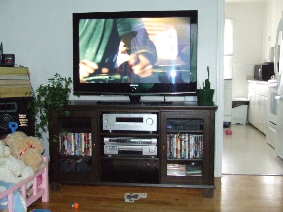 Living room scene with a large television on a media console