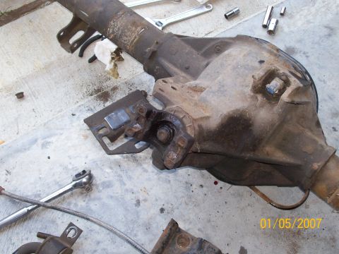 1996 Ford Bronco - A differential axle assembly is shown on a concrete surface with various tools scattered around it.
