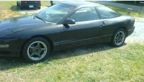 1996 Ford Probe - A black 1996 Ford Probe is seen from the side and front-quarter angle.