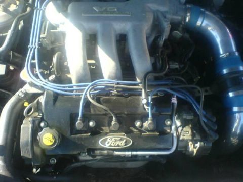 1996 Ford Probe - The engine bay features a V6 engine with prominent Ford branding on the valve cover.