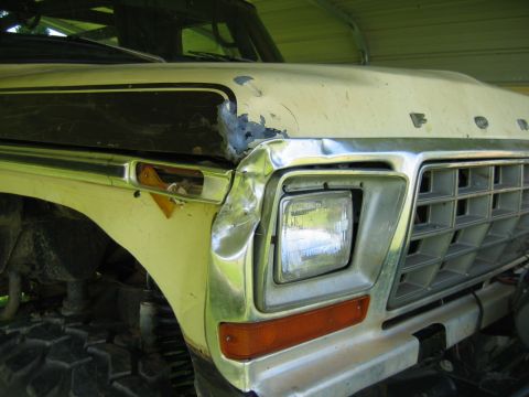1992 Ford Mustang - Front view of a damaged cream-colored Ford truck with a chrome grille and square headlight.
