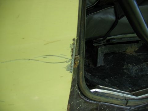 1992 Ford Mustang - Close-up view of a vehicle's interior door frame and seat, showing signs of wear and rust.