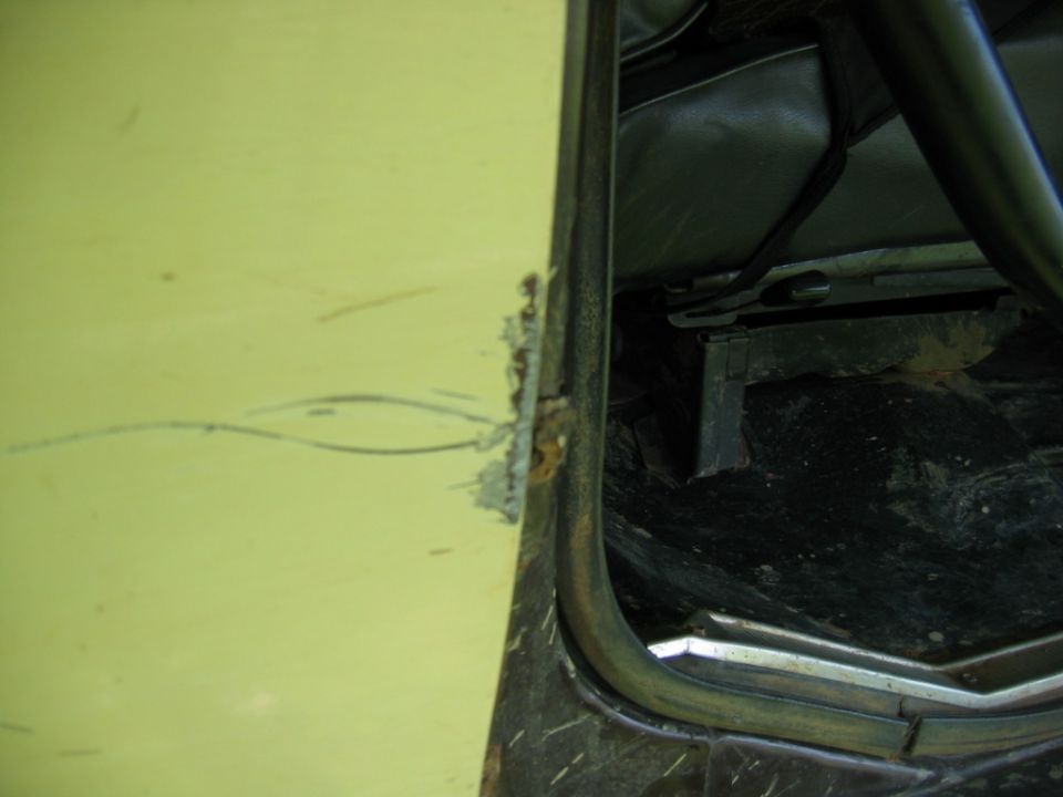 Yellow door frame with rust and interior seat visible