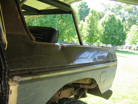 1992 Ford Mustang - The rear section of a pickup truck shows damage and wear, with a roll bar visible through the window.