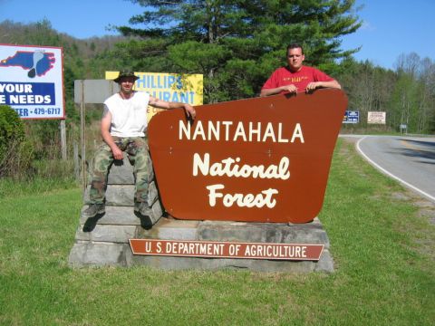1992 Ford Mustang - Two men pose for a photo in front of the Nantahala National Forest sign.