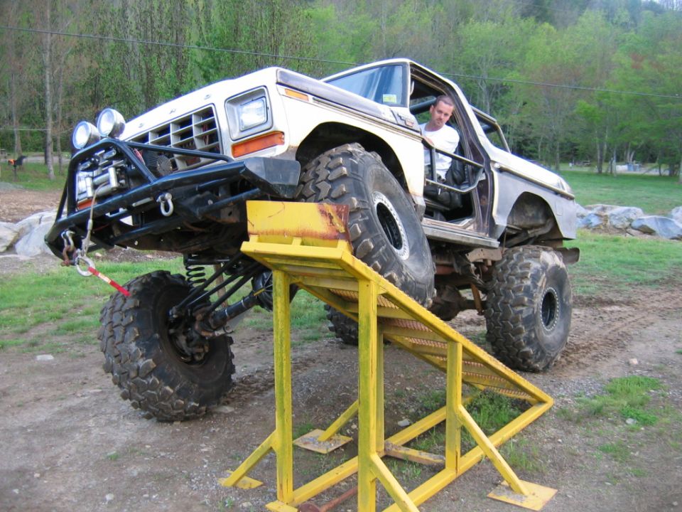 Modified 1979 Ford F-Series truck with large tires and off-road bumper on a yellow ramp