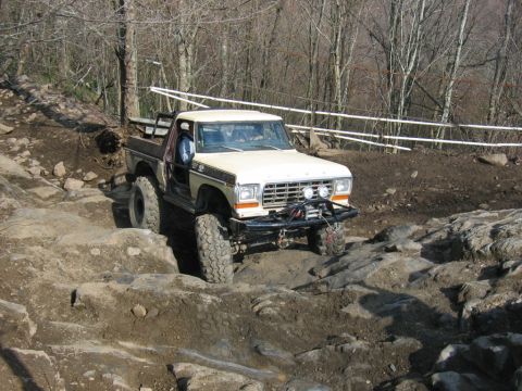 1992 Ford Mustang - This modified pickup truck is tackling a challenging rocky off-road course.