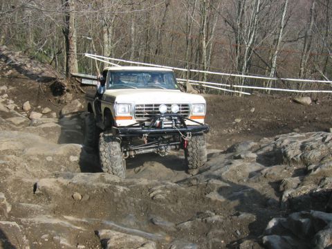 1992 Ford Mustang - A modified pickup truck navigates a rocky off-road course.
