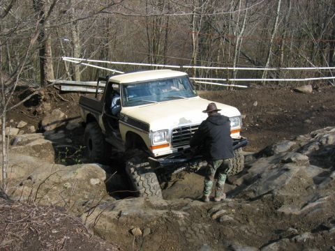 1992 Ford Mustang - A modified pickup truck tackles a challenging off-road course with large tires and a lifted suspension.