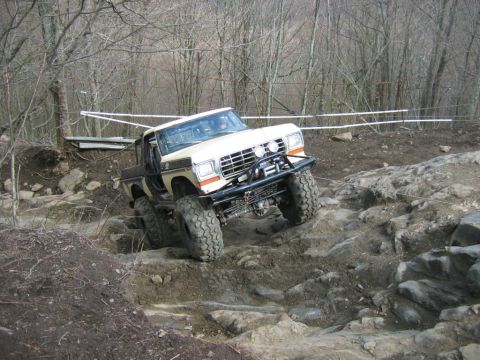 1992 Ford Mustang - A modified pickup truck navigates a challenging rocky terrain during an off-road event.