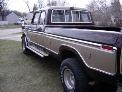 1979 Ford Bronco - This pickup truck features a two-tone paint scheme with chrome accents and running boards, viewed from the front three-quarter angle.