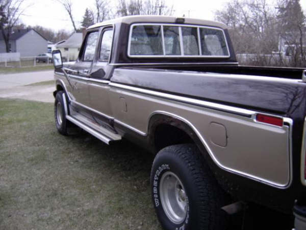 Two-tone pickup truck, side view. Chrome trim, running boards, and silver wheels