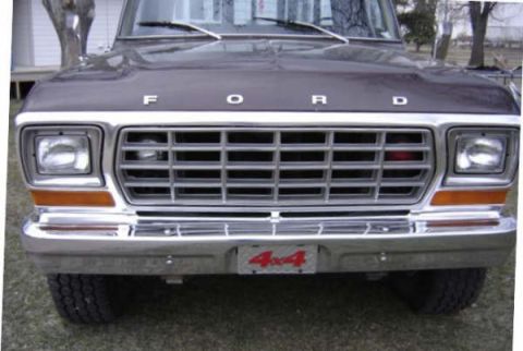 1979 Ford Bronco - The front grille and bumper of a 1979 Ford Bronco are visible, the Ford lettering across the hood.