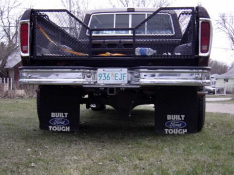 1979 Ford Bronco - Rear view of a black 1979 Ford Bronco, showing its chrome bumper and mud flaps.