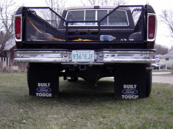 Black 1979 Ford Bronco rear view with chrome bumper and "Built Ford Tough" mud flaps