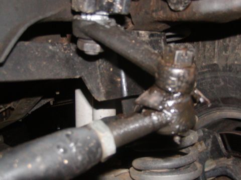 1991 Ford Bronco - This image shows a close-up of a vehicle's steering linkage, focusing on the tie rod ends and ball joints.