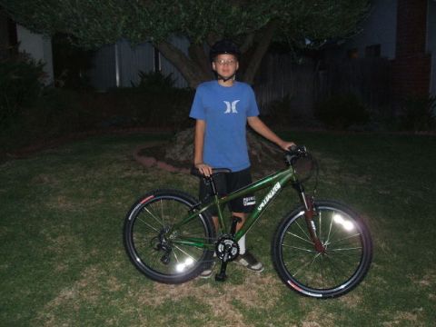 1988 Ford Bronco - A boy poses with his bicycle in a yard at night, with a tree overhead.