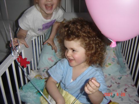 1993 Ford Bronco - Children celebrate with a large pink balloon inside a crib.