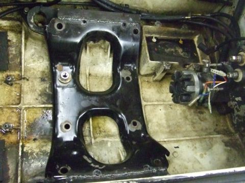 1995 Ford Mustang - Close-up view of a black engine mount bracket, likely from a watercraft, showing its structural design and mounting points.