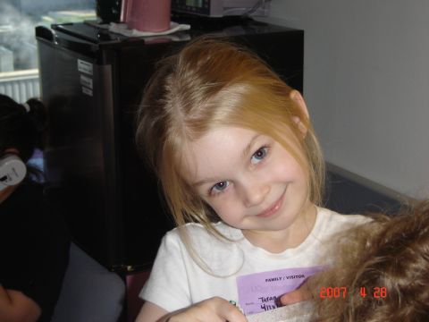 1993 Ford Bronco - A young girl with blonde hair and blue eyes smiles for the camera, holding a visitor pass.