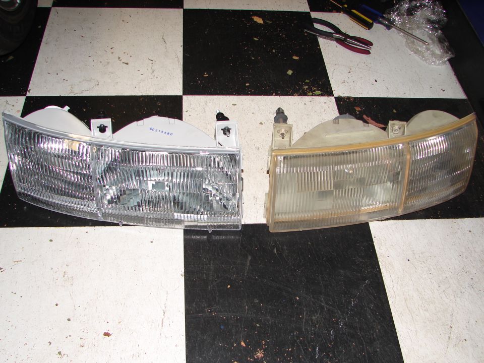 Two car headlights on a checkered floor; one is clear and new, the other is yellowed and old