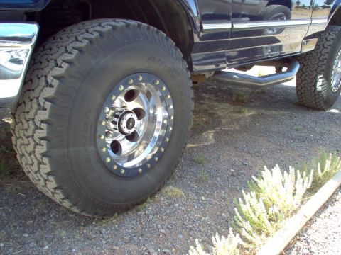 1995 Ford Bronco - 1995 Ford Bronco with custom wheels and side step shown from the side.