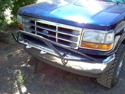 1995 Ford Bronco - Front view of a blue Ford Bronco with a custom bumper and chrome grille.
