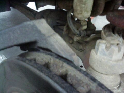 1995 Ford Bronco - Undercarriage view of suspension components, showing wear and tear.