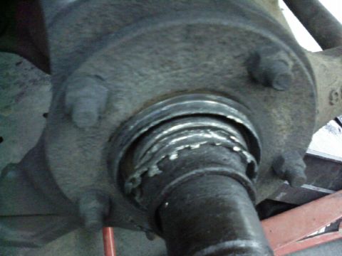 1995 Ford Bronco - This image shows a close-up view of a damaged wheel hub assembly, highlighting wear and tear on the component.