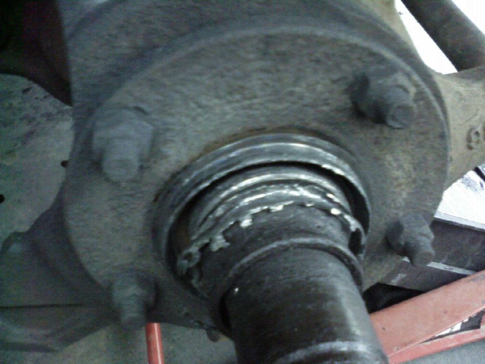 Close-up of a damaged wheel hub assembly with visible wear