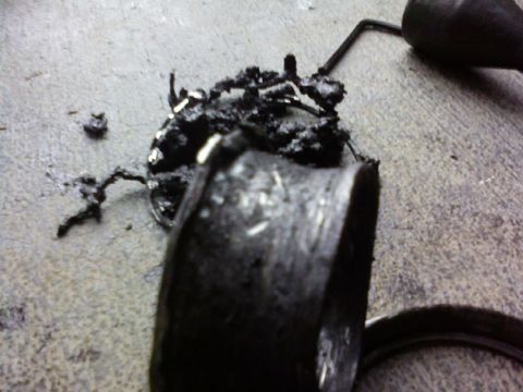 1995 Ford Bronco - A damaged fuel pump assembly lies on a concrete surface, showing signs of wear and tear.
