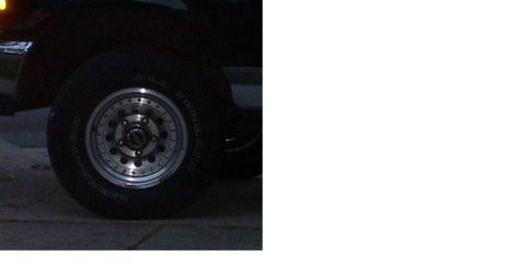1992 Ford Bronco - Close-up of a 1992 Ford Bronco wheel and tire, showing aftermarket chrome rims.