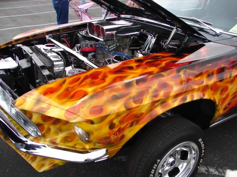 1992 Ford Taurus - This custom hot rod features a vibrant flame paint job and a highly detailed engine bay with chrome accents.