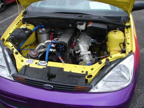 1992 Ford Taurus - Customized engine bay a turbocharger and vibrant yellow and purple paint scheme.
