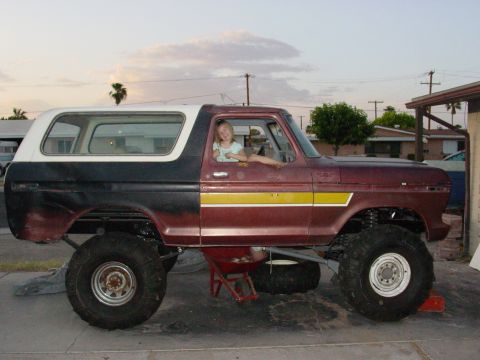 1979 Ford Bronco - This lifted 1979 Ford Bronco features a two-tone paint scheme and a young driver enjoying the view.