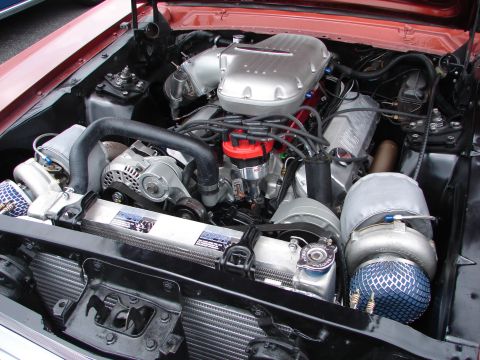 1992 Ford Taurus - A heavily modified engine bay shows a turbocharger and custom components, indicating significant performance upgrades.