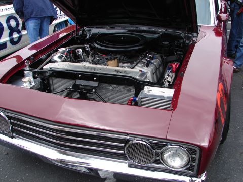 1992 Ford Taurus - Engine bay of a classic car, with another vehicle visible in the background.
